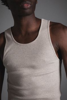 An essential lightweight tank for layering. Made with a slightly longer length in single-stitched 100% cotton rib. Garment washed for a vintage feel. 100% ORGANIC COTTON 5 OZ SOFT RIB STANDARD FIT SINGLE STITCHED Basic Relaxed Fit Tank Top For Everyday, Casual Cotton Ribbed Tank Top, Casual Ribbed Cotton Tank Top, Fitted Casual Everyday Vest, Classic Seamless Everyday Tank Top, Classic Everyday Seamless Tank Top, Casual Ribbed Racerback Vest, Organic Cotton Tank Top For Spring, Crew Neck Ribbed Cotton Tank Top