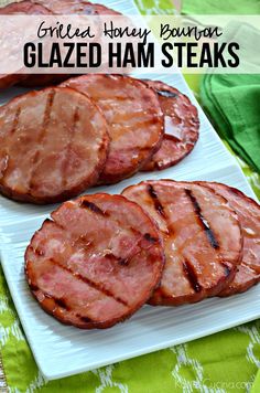 grilled ham steaks on a white plate with text overlay that reads grilled honey bacon glazed ham steaks