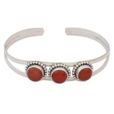 Three carnelians the birthstones of July glow with bright elegance in the design of this cuff bracelet. India's Neeru Goel presents a bracelet that is masterfully crafted by hand of sterling silver. .925 Sterling silver Carnelian Bangle Bracelet Gift, Carnelian Bracelet Jewelry Gift, Adjustable Carnelian Bracelet Perfect For Gifts, Elegant Red Carnelian Bracelet, Adjustable Carnelian Bracelet As A Gift, Adjustable Cabochon Bangle Bracelets, Elegant Carnelian Gemstone Bracelets, Elegant Round Carnelian Bracelets, Adjustable Spiritual Bangle For Formal Occasions