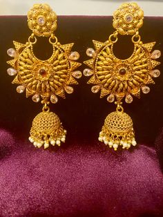 Enhance your Indian outfit with these exquisite Antique Ruby Pearl Earrings. The antique design and stunning combination of ruby pink , white stones and pearl will add a touch of elegance and sophistication to any look. Perfect for formal occasions these earrings are a must-have for any jewelry collection. Length - 3.5 inch ; width- 1.8 inch Jewellery Care- Keep the jewelry dry, avoid heat and contact with perfumes & water. Elegant Jeweled Earrings For Reception, Gold Jeweled Chandbali Pearl Earrings, Elegant Jeweled Chandbali Pearl Earrings, Festive Jeweled Bridal Earrings For Formal Occasions, Elegant Jeweled Danglers For Celebrations, Gift Stone Work Pearl Drop Earrings, Traditional Jeweled Pearl Earrings For Party, Festive Gold Plated Jeweled Bridal Earrings, Gift Pearl Drop Earrings With Stone Work