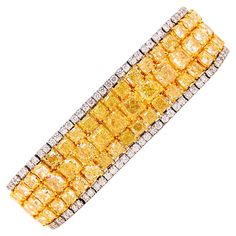 Showcasing a knockout natural yellow diamond bracelet with approximately 46.81ct total weight. Measures 1.80cm wide or 3/4 of an inch and 7 inches long. The color hue and saturation in our opinion face up as fancy intense after setting! Every diamond is full of fire. Hand made in the Emilio Jewelry Atelier, whom specializes in rare collectible pieces in the fancy color diamond field. The clarity of the diamonds are vs1 -vs2 overall. VIDEO AVAILABLE. Please inquire for more images, the certificat Yellow Diamond Bracelet, Emilio Jewelry, Jewelry Atelier, Yellow Diamond Jewelry, Fire Hand, Modern Bangle, Graff Diamonds, Flexible Bracelet, Retro Bracelet