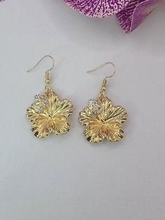 Pretty hibiscus flower earrings with crystal accents. Tarnish resistant ear hooks. 14kt Gold 'pinoy' /filipino Sunkiss Earrings, Elegant Dangle Flower Earrings For Beach, Gold Beach Jewelry With Flower Charm, Gold Jewelry With Flower Charm For Beach, Elegant Flower Shaped Earrings For Beach, Elegant Flower-shaped Earrings For Beach, Gold Flower Jewelry For Beach, Elegant Flower-shaped Beach Earrings, Gold Flower Earrings For Beach