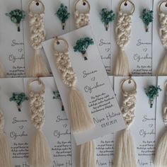 wedding cards with tassels and flowers are arranged on the table for guests to sign