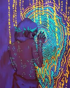 a woman is standing in front of an art piece with neon lights on her body