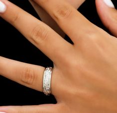 a woman's hand with a wedding ring on it