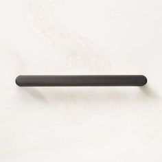 a black handle on a white wall