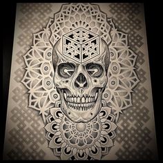 a black and white drawing of a skull with an intricate design on it's face