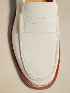 A time-honored classic, this classic loafer comes to life, ready for all seasons with a luxurious, Italian suede.  Italian suede uppers.  Slip-on styling.  Blake-stitch leather soles.  Made in Portugal.  Whole and half sizes. Cream Loafers, White Dress Shoes Men, White Loafers, White Shoes Men, White Dress Shoes, Guys Clothing Styles, Futuristic Fashion, Penny Loafer, Stitching Leather