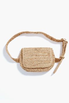 the small straw bag is made from natural materials and has an adjustable strap to hold it