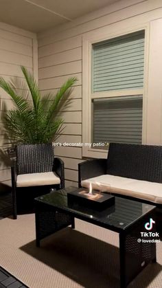 two wicker chairs and a coffee table in front of a window