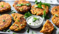 several crab cakes with sour cream and cilantro