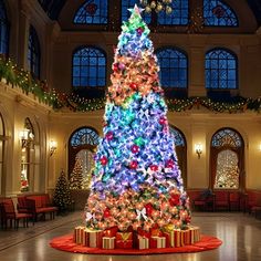 a brightly lit christmas tree in the middle of a room