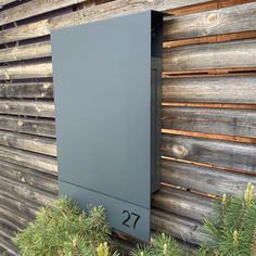 a house number sign mounted to the side of a wooden building