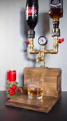 a wooden tray topped with two glasses filled with liquid next to an old fashioned faucet