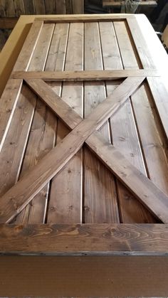 a close up of a wooden table with an open barn door on the top and bottom