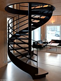 a spiral staircase in the middle of a living room