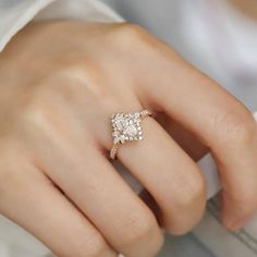 a woman's hand with a diamond ring on it