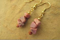 Rhodochrosite earrings gemstone earrings chip earrings pink earrings pink gemstone earrings gifts. These beautifully crafted earrings feature rhodochrosite chip beads and wooden beads on gold plated hook wires. Rhodocrosite is a popular gem with a subtle dusty pink colour. The earrings have a 4cm drop and the chip beads average 5-8mm in size. Gold Gemstone Bead Drop Earrings, Gold Drop Earrings With Gemstone Beads, Gemstone Bead Drop Earrings For Gifts, Adjustable Gemstone Bead Drop Earrings, Dainty Pink Jewelry With Gemstone Beads, Dainty Drop Earrings With Natural Stones, Pink Gemstone Dangle Jewelry, Pink Gemstone Drop Earrings, Dainty Dangle Jewelry With Gemstone Beads