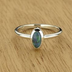 Blue Green Oval Opal Ring for Women Bezel Set Opal in 925 Sterling Silver INSTOCK Size 6.5US only FEATURES: * Solitaire Oval Ring * Semi Black Opal, NSW * Everyday Pendant * Minimalist Stylingv * Lifetime Warranty * Flexibility Shipping Services & Free over $500 * Shipped with Insurance & Tracking * Authenticity Certified * Completely Handmade OPAL DETAILS: Number of Opals: 1 Opal Type: Semi Black Opal Total Carat Weight (cwt): 0.44 Overall Dimensions (mm): 3.6 x 6.8 x 2.7 Shape: Oval Transparen Oval Opal Ring, Everyday Pendant, Lemon Quartz Ring, Promise Rings For Guys, Black Opal Ring, Faceted Ring, Ring Settings, Lightning Ridge, Spinner Rings