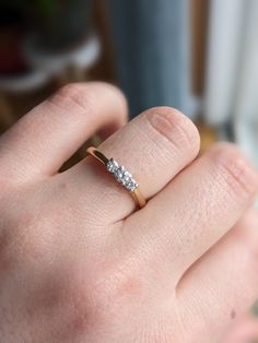 a woman's hand with a diamond ring on it