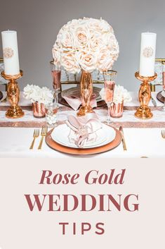 rose gold wedding tips with white flowers and pink napkins on the table, surrounded by candles