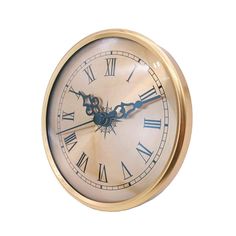 a gold clock with roman numerals is shown against a white background and shows the time