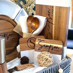 a basket filled with wooden spoons and other kitchen utensils on top of a table