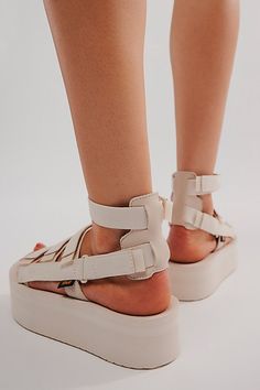 Reach new heights in these upgraded Teva gladiator-style sandals featuring an elevated flatform sole and organic cotton straps with multiple points of adjustability for your perfect fit. * Hook-and-loop closures for adjustable fit * Rubber sawtooth outsole * Molded EVA midsole * Removable ankle strap | Teva Flatform Mevia Sandals at Free People in White, Size: US 10 Spring Beach Footbed Sandals With Chunky Platform, Summer Footbed Sandals With Chunky Platform And Round Toe, Chunky Platform Footbed Sandals For Summer, Casual Footbed Sandals With Chunky Platform For Spring, Spring Platform Footbed Sandals With Flat Heel, Spring Platform Footbed Sandals, Spring Flat Heel Platform Footbed Sandals, Spring Platform Flat Footbed Sandals, Spring Beige Synthetic Sport Sandals