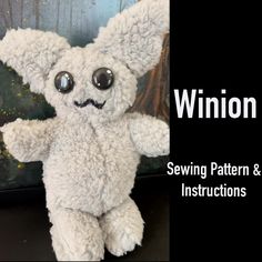 a white stuffed animal with big eyes sitting in front of a black sign that says winton street sewing pattern and instructions