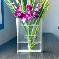 a clear vase with purple flowers in it