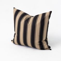 a black and beige striped pillow on a white background