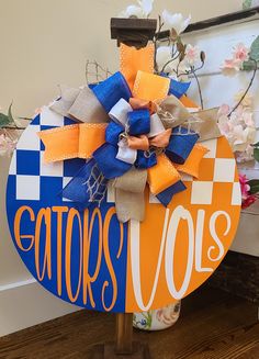 an orange and blue sign with the word carrots volls on it sitting next to flowers