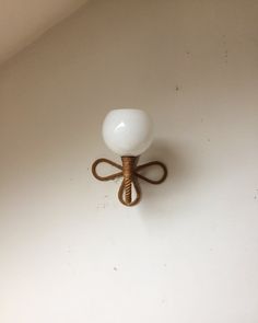 a light that is on the wall with a rope attached to it's side