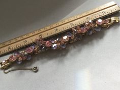 "Delizza and Elster, Juliana design with pink rhinestones and givre lavender satin glass teardrop accents. Beautiful, sparkling diamond like gems on this lovely link bracelet with a gold finish. A larger pink chaton is on a link that links two other ornate gem clusters. A total of five clusters and six large gem connectors. There is a chain guard as well as the very secure clasp. Wear this lovely bracelet on your fanciest outing. Quite a stunning and rare Juliana by Deliza and Elster from their Elegant Pink Jeweled Bracelets, Pink Crystal Bracelet With Sparkling Stones For Party, Elegant Pink Bling Bracelets, Pink Crystal Bracelet For Formal Occasions, Pink Crystal Bracelets For Formal Occasions, Pink Evening Jewelry With Bling, Pink Bling Jewelry For Evening, Formal Pink Crystal Bracelet, Evening Pink Bling Jewelry