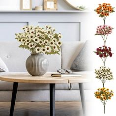 a vase with flowers sitting on top of a table in front of a couch and mirror