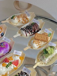 a glass table topped with lots of different desserts