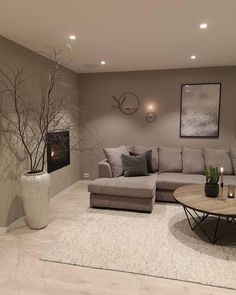 a living room filled with lots of furniture and decor on top of a white rug