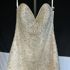 a wedding dress hanging on a hanger