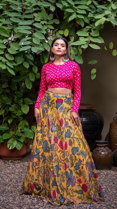 Mustard Yellow soft silk printed lehenga set comes with closed neck bandhani blouse in pink color which features full sleeves and closed back with hook-eye opening. Color of Lehenga - Mustard Yellow. Color of Crop Top - Pink. Fabric of Lehenga- Printed Soft Silk. Fabric of Crop Top - Modal Silk. Number of components - 2. Measurements in the size chart are all garment measurements. The actual print-placement of the product may vary slightly from the image shown. Standard Lehenga Length - 43". Sta Festive Ikat Print Sets With Long Sleeves, Pink Block Print Saree Sets, Festive Art Silk Choli With Printed Motifs, Bollywood Ikat Print Blouse Piece For Festivals, Bollywood Choli With Printed Motifs For Diwali, Festive Ikat Print Long Sleeve Sets, Bollywood Style Diwali Choli With Printed Motifs, Pink Unstitched Lehenga With Printed Motifs, Pink Anarkali Set With Kalamkari Print