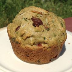 a close up of a muffin on a plate with grass in the background,