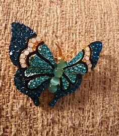 Beautiful aqua blue and green rhinestone 🦋 brooch. Beautiful as a gift for any occasion. Quick Shipping. Costume Jewelry Blue Brooches With Rhinestones, Green Jeweled Brooch For Gift, Blue Brooch Pin As Gift, Green Jeweled Brooches As Gift, Blue Brooch Pin For Gift, Blue Brooch Pins As A Gift, Blue Brooch Pins For Gift, Elegant Blue Butterfly Brooches, Green Costume Jewelry Brooches For Gifting