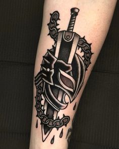 a black and white tattoo on the leg of a person with a knife in his hand