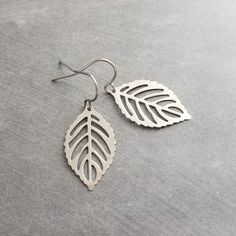 Hypoallergenic little solid stainless steel leaves with a modern cut-out filigree design. Hung on small simple stainless steel hooks. Very lightweight and easy to wear- like they're not even there! These will include little clear silicone rubber stoppers for extra secure wear. If you're not familiar with the look of stainless steel jewelry, it is a darker metallic silver-grey finish- similar to a pewter color. { M e a s u r e m e n t s } Envisioning measurements online is HARD and I don't want y Silver Leaf Earrings, Leaf Earring, Pewter Color, Crochet Simple, Filigree Design, Stainless Steel Earrings, Leaf Earrings, Steel Jewelry, Stainless Steel Jewelry