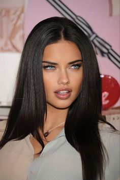 a woman with long black hair and blue eyes