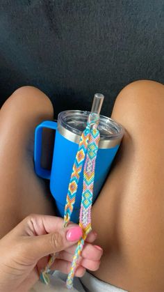 a woman holding onto a cup with a straw in it