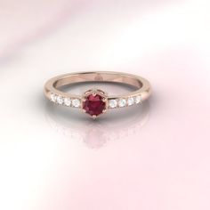 "The ruby Rarissime ring by ASCHERON. The word \" Rarissime \" means extremely rare. The Rarissime ring evokes the feeling of finding your soulmate. Ruby and diamond engagement ring by ASCHERON. Vintage inspired diamond ring with a hexagonal setting and fine millgrain detail. Tiny heart patterns are cut into the side of the setting. ASCHERON is bespoke jewelry design brand. Our pieces are excellent quality and are highly collectible. Gemstone - real ruby gemstone measuring 4mm round. Diamonds - Luxury Ruby Ring With Center Stone For Promise, Luxury Promise Ruby Ring With Center Stone, Ruby Ring With Center Stone For Promise, Promise Ruby Ring With Round Cut Center Stone, Promise Ruby Ring With Center Stone, Solitaire Ruby Ring For Promise, Ruby Diamond Ring With Rose Cut For Promise, Ruby Promise Ring With Rose Cut Diamonds, Promise Ring With Rose Cut Diamonds And Lab-created Ruby