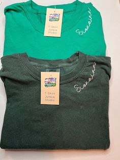 *Photo Listing is Crunchberry with Cream Thread Farmhouse Font* Rep your favorite player, team, group, organization, whatever it might be you will love these custom embroidered long sleeve Comfort Colors t-shirts. Embroidered along the neckline, you can put whatever you would like for this to say, leave this information in the personalization box below.   Please keep word length to a minimum, the neckline is only so big and for it to turn out great keep that in mind when deciding.  If you want a Green Crew Neck T-shirt With Custom Embroidery, Casual Embroidered Crew T-shirt, Green Embroidered Text Short Sleeve T-shirt, Green Embroidered Crew Top, Green Embroidered Crew Neck Top, Relaxed Fit Crew T-shirt With Custom Embroidery, Custom Embroidered Relaxed Fit Crew T-shirt, Green Crew Neck T-shirt With Embroidered Graphics, Relaxed Fit Green Top With Embroidered Logo