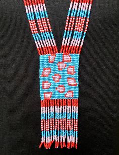 Cheetah pattern colorful long seed bead necklace with fun fringe. This necklace says summer, beach, resort. Necklace measures 16 inches, pendant measures 4 1/2 inches from top to the bottom of the fringe. No clasp, just slip over your head. Striking with a swingy beach dress or a jean jacket. Shop more necklaces here: https://www.etsy.com/shop/BoutiqueByMaryam?section_id=21694658 Be sure to visit the rest of my shop here: https://www.etsy.com/shop/boutiquebymaryam Multicolor Southwestern Beaded Necklace With Dangling Beads, Traditional Beaded Necklaces For Summer Festivals, Artisan Multicolor Beaded Necklaces With Fringe, Southwestern Style Multicolor Necklaces With Dangling Beads, Artisan Multicolor Beaded Necklace With Fringe, Traditional Multicolor Beaded Fringe Necklaces, Traditional Multicolor Beaded Necklaces With Fringe, Southwestern Multicolor Dangling Beads, Multicolor Southwestern Style Dangling Beads