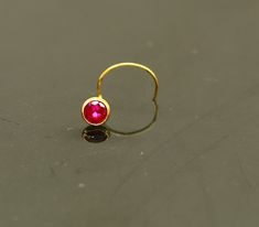 18 kt or 18 carat yellow gold handmade excellent single stone nose L band nose stud. Fabulous red color stone looking  pretty, excellent  bridesmaid , customized personalized jewelry from india. Metal-18 kt yellow gold. Item type-nose pin. Weight-0.060 grams. size-3.5 mm approx(top with stone) Closure- U band. Makes excellent gifting for birthday,mother's day. valentines day, Christmas day, wedding anniversary. Red Stone Jewelry, Cute Nose Piercings, Nose Pin, Baby Bracelet, Nose Jewelry, Nose Ring Stud, Single Stone, Nose Stud, Color Stone