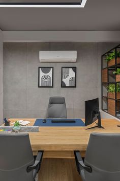 an office with a wooden table and gray leather chairs in front of a wall mounted air conditioner